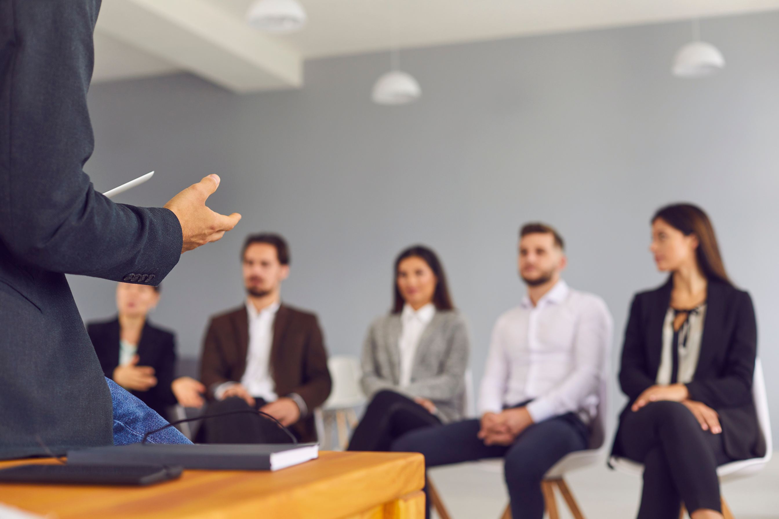 Hands of Businessman Speaker Presenting Project or Making Training for Group of Business People